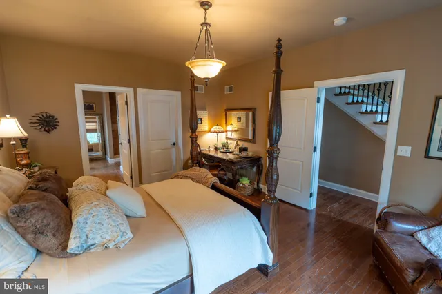 a bed room with a bed window and a chair