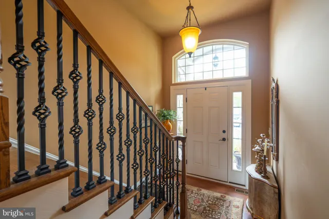 a view of an entryway with wooden floor and stairs