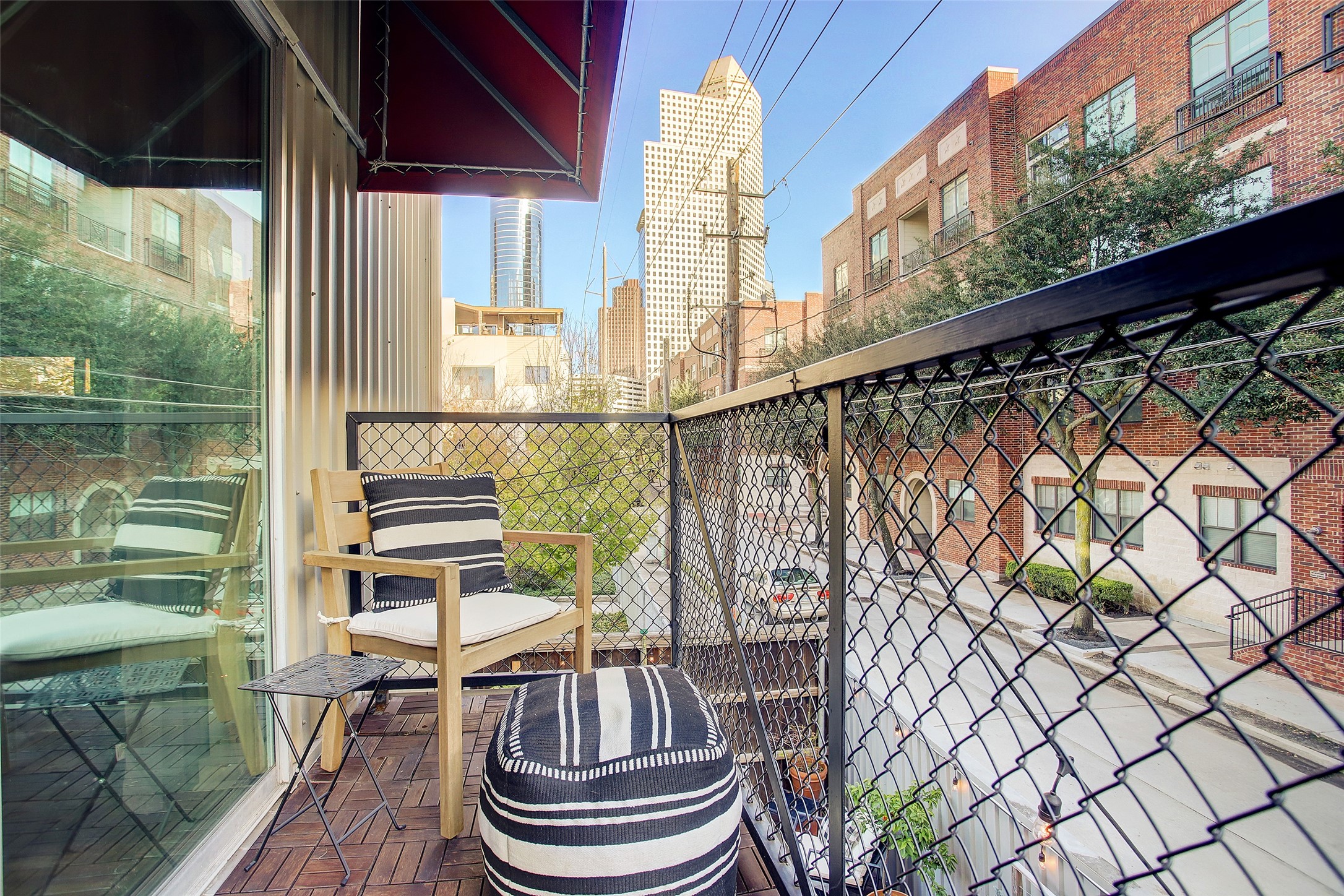 816 Ruthven Street Houston, TX 77019 - Photo 9 of 39 Experience urban living at its best with this charming second-floor balcony offering stunning city views and a cozy space for relaxation.