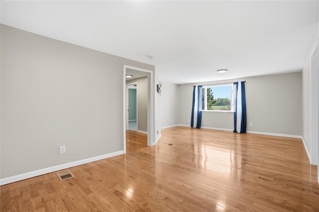 213 Fallen Timber Road Avella, PA 15312 - Photo 22 of 44 The living room leads to the bedrooms and full bathroom, featuring an oversized window that allows plenty of natural sunlight in and picturesque countryside views.