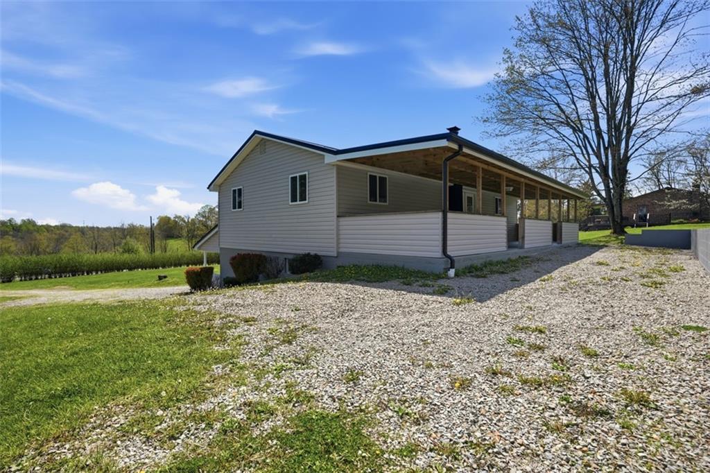 213 Fallen Timber Road Avella, PA 15312 - Photo 27 of 44 Enjoy the back patio and a wraparound driveway that provides plenty of parking space.