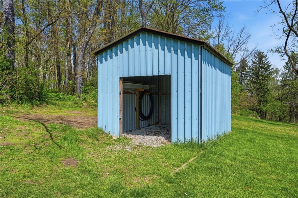 213 Fallen Timber Road Avella, PA 15312 - Photo 31 of 44 The shed provides ample space for lawn equipment, gardening tools, and additional storage needs.