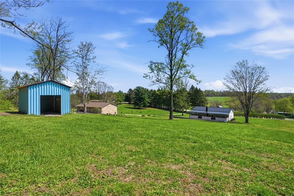 213 Fallen Timber Road Avella, PA 15312 - Photo 33 of 44 The backyard is perfect for outdoor games, celebrations, and creating lasting memories in a peaceful setting.