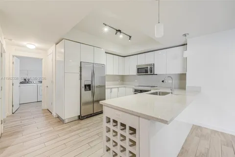 a kitchen with stainless steel appliances a refrigerator and a stove top oven