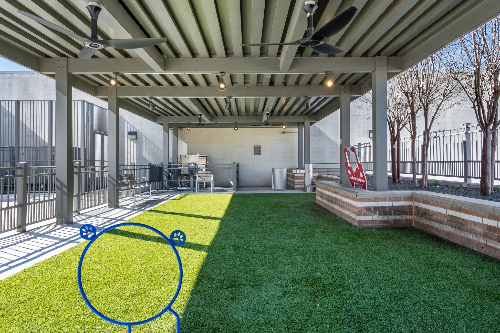 2724 Kipling Street, Unit 436 Houston, TX 77098 - Photo 19 of 29 This pet-friendly amenity is a lifestyle-focused design, providing a premium outdoor space that caters equally to pets and their owners. By integrating high-end architectural elements into a functional play area, it elevates the concept of a "dog park" into a sophisticated outdoor lounge.