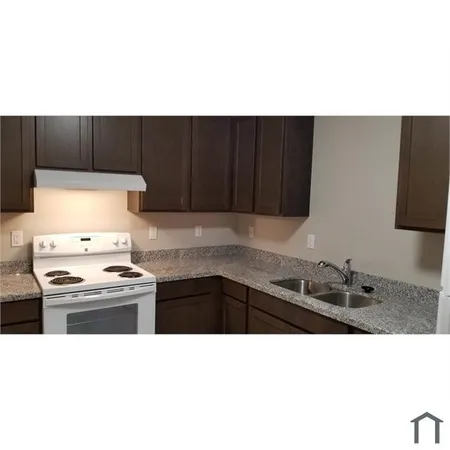 a kitchen with a cabinets and appliances