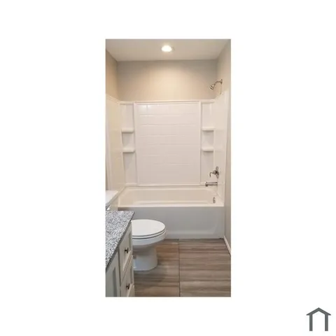 a bathroom with a toilet a sink and a bathtub