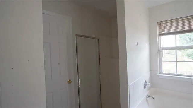 a bathroom with a bathtub and a shower