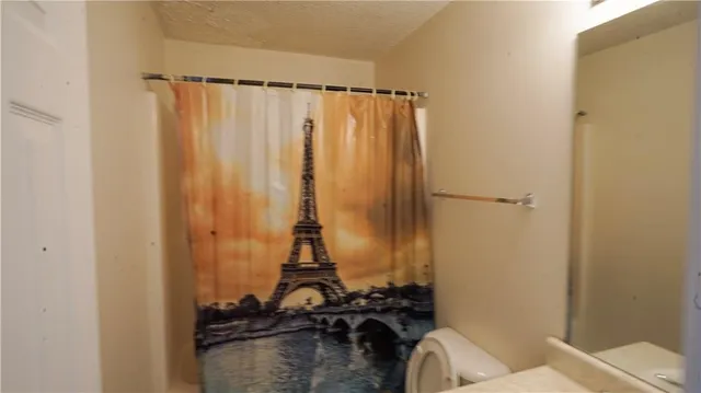 a view of a bathroom with a shower curtain