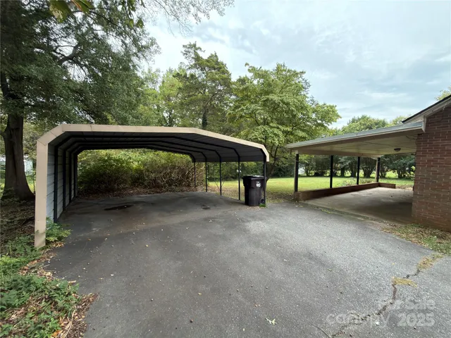 a view of patio with table and chairs and floor to ceiling window