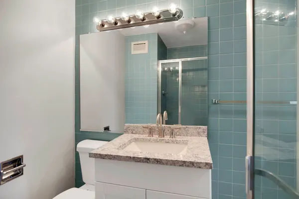 a bathroom with a sink and shower