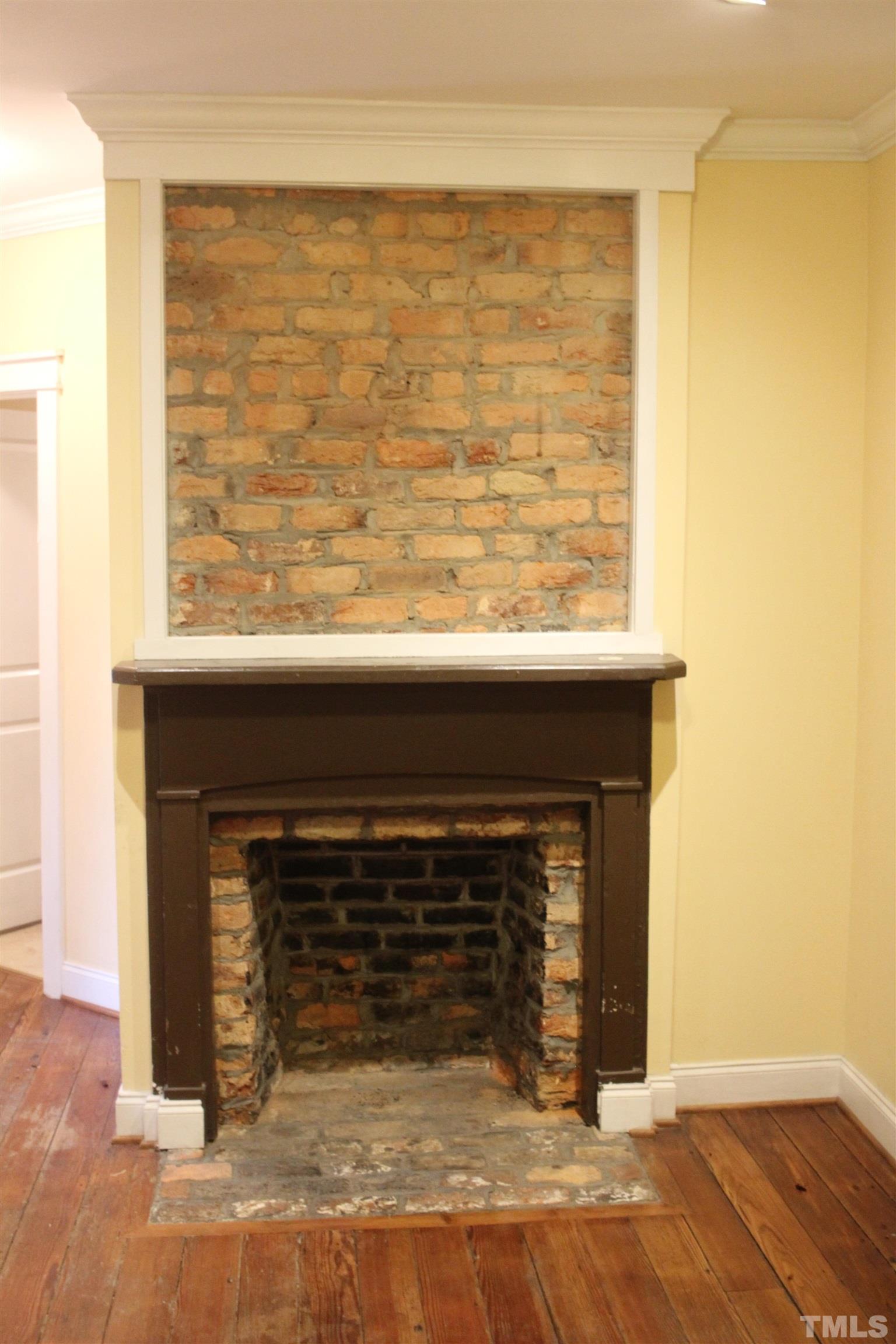 815 East Davie Street Raleigh, NC 27601 - Photo 5 of 21 a view of a livingroom with wooden floor and a fireplace