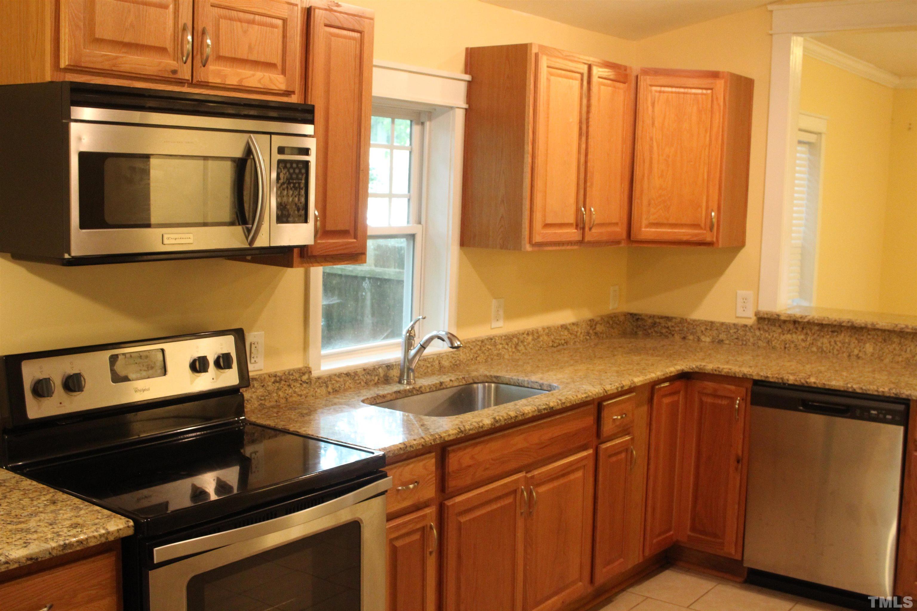815 East Davie Street Raleigh, NC 27601 - Photo 8 of 21 a kitchen with a sink and a microwave