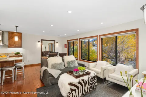 a bedroom with furniture and a large window