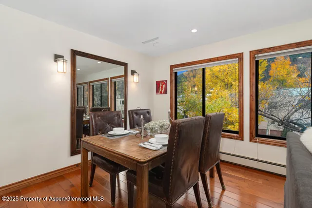 a view of a dining room with furniture window and wooden floor