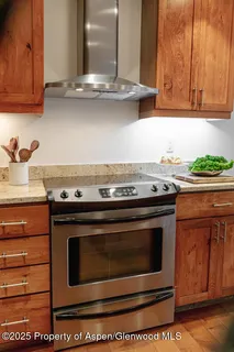 a stove top oven sitting inside of a kitchen