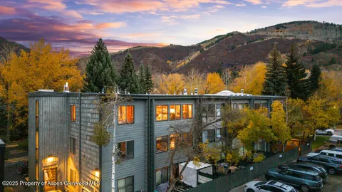 a backyard of a house with barbeque oven and outdoor seating