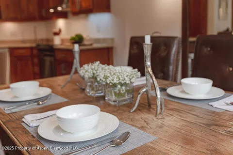 a kitchen with a table and a fireplace