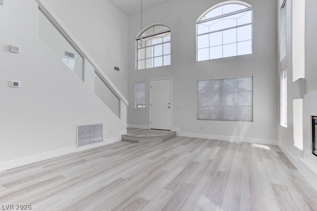1 Rising Sun Court Henderson, NV 89074 - Photo 5 of 47 The bright open-concept living area features soaring ceilings and elegant wood-look flooring.