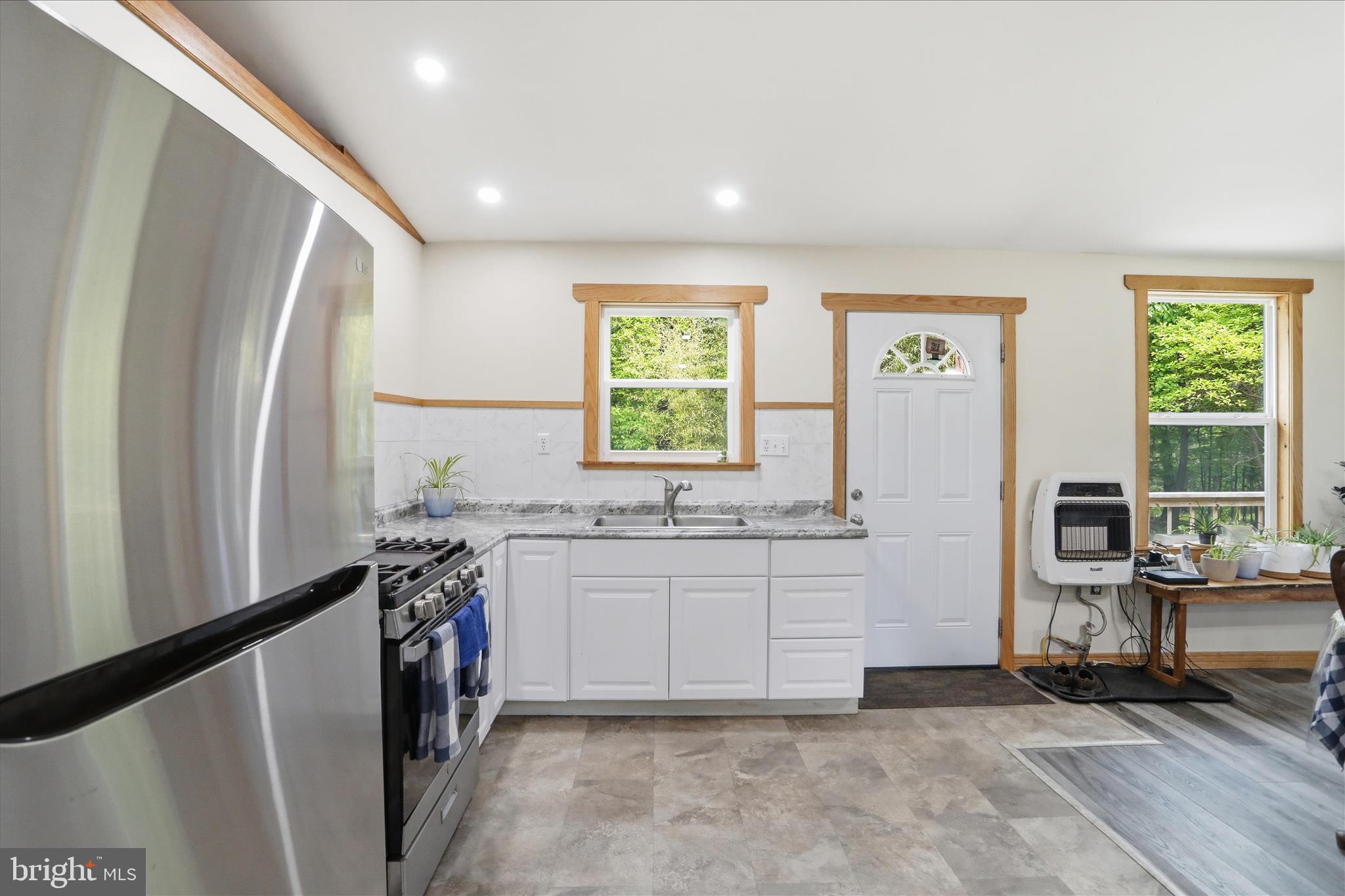 936 Johnny Cake Road Great Cacapon, WV 25422 - Photo 10 of 33 a kitchen with sink refrigerator and window