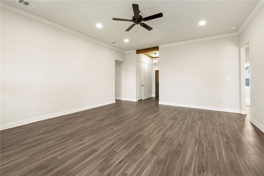 2813 Spector Drive Bryan, TX 77808 - Photo 11 of 42 a view of a room with wooden floor and a ceiling fan
