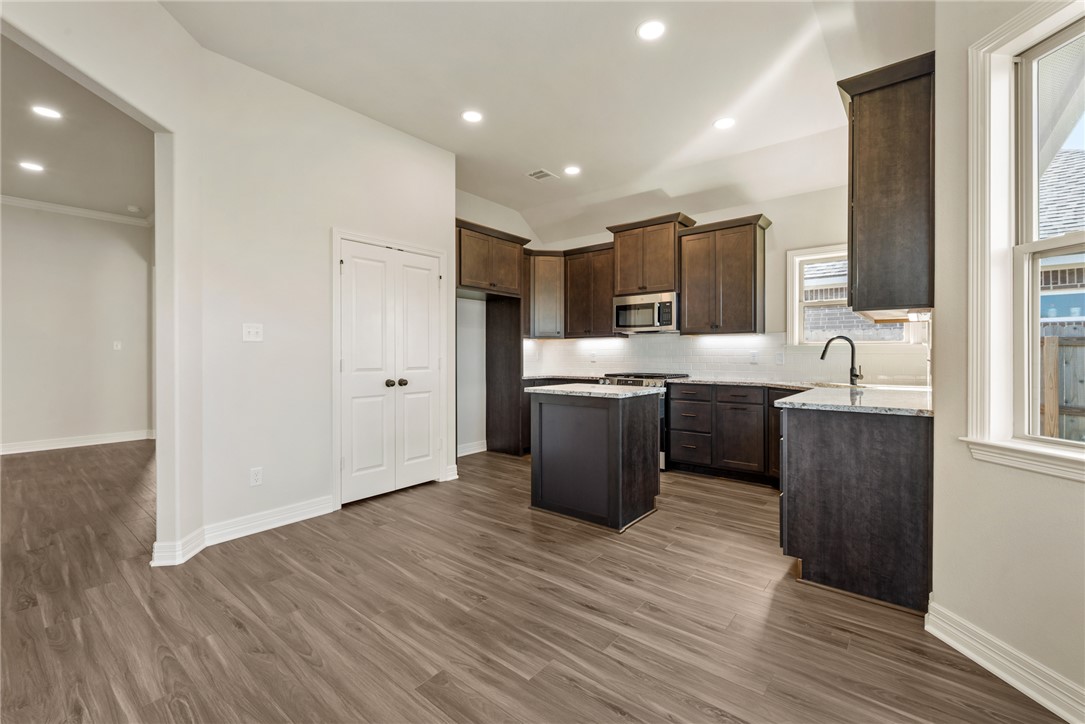 2813 Spector Drive Bryan, TX 77808 - Photo 14 of 42 a kitchen with stainless steel appliances a sink a stove a refrigerator and cabinets