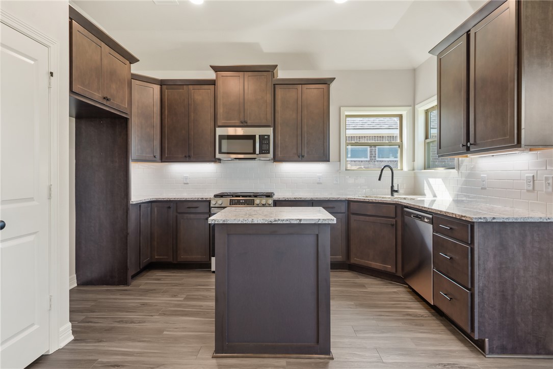 2813 Spector Drive Bryan, TX 77808 - Photo 17 of 42 a kitchen with stainless steel appliances granite countertop a sink stove and refrigerator