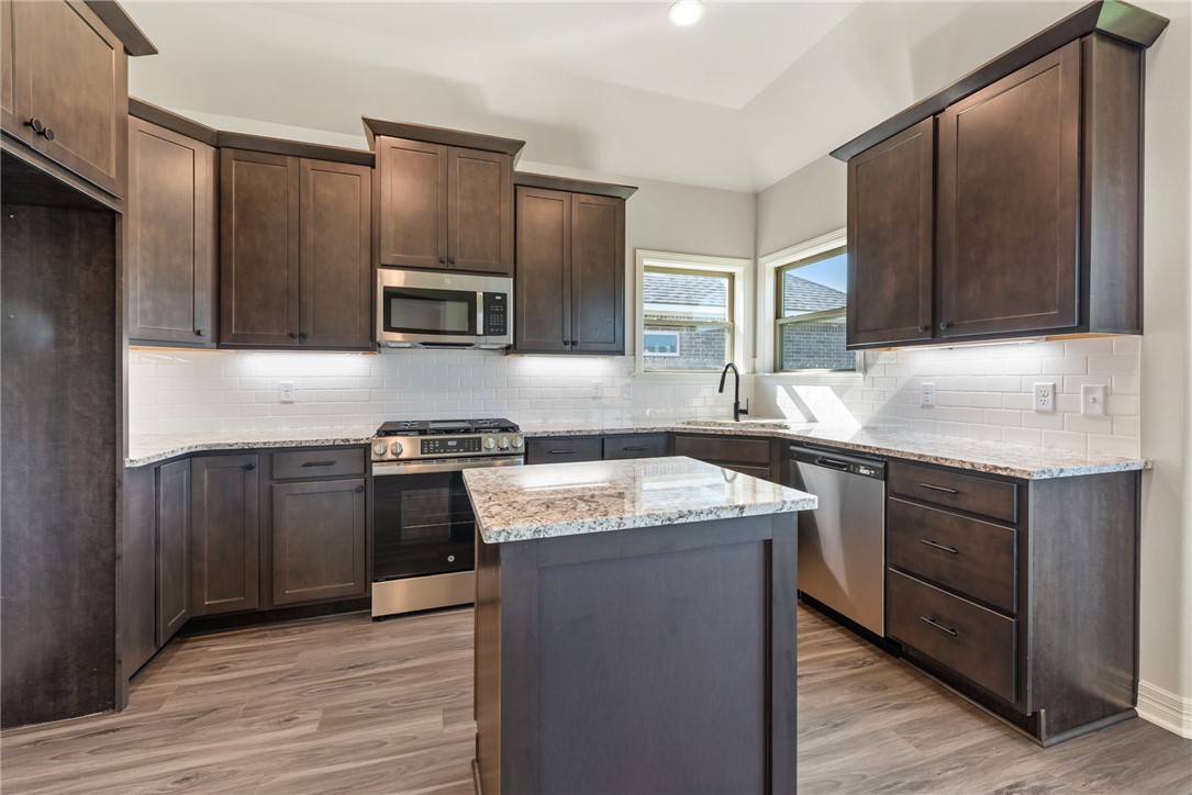 2813 Spector Drive Bryan, TX 77808 - Photo 20 of 42 a kitchen with stainless steel appliances granite countertop a sink stove and microwave