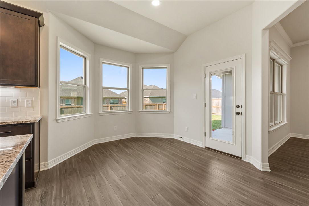 2813 Spector Drive Bryan, TX 77808 - Photo 22 of 42 a view of an empty room with wooden floor and a window