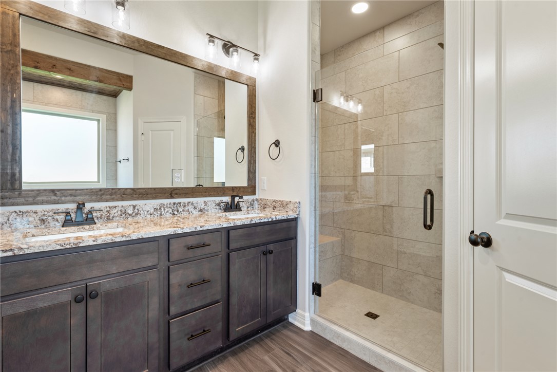 2813 Spector Drive Bryan, TX 77808 - Photo 29 of 42 a bathroom with a shower sink and mirror