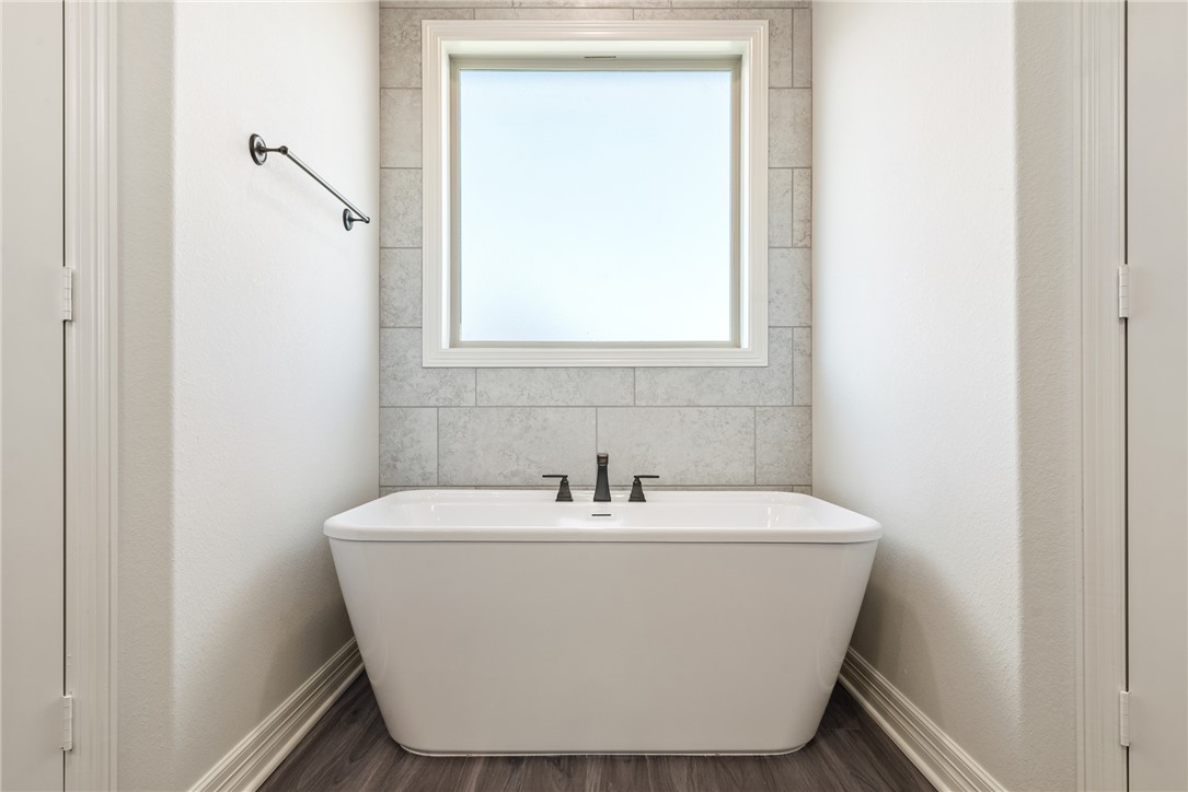 2813 Spector Drive Bryan, TX 77808 - Photo 32 of 42 a white bath tub sitting in a bathroom