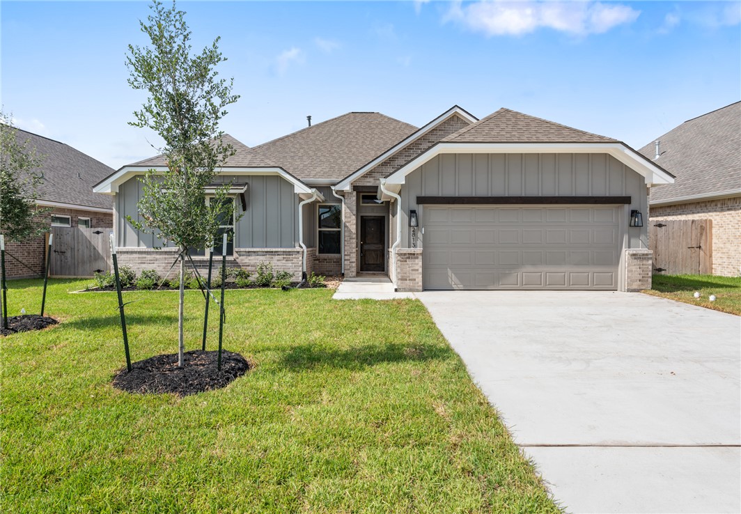 2813 Spector Drive Bryan, TX 77808 - Photo 4 of 42 a front view of a house with a yard and garage