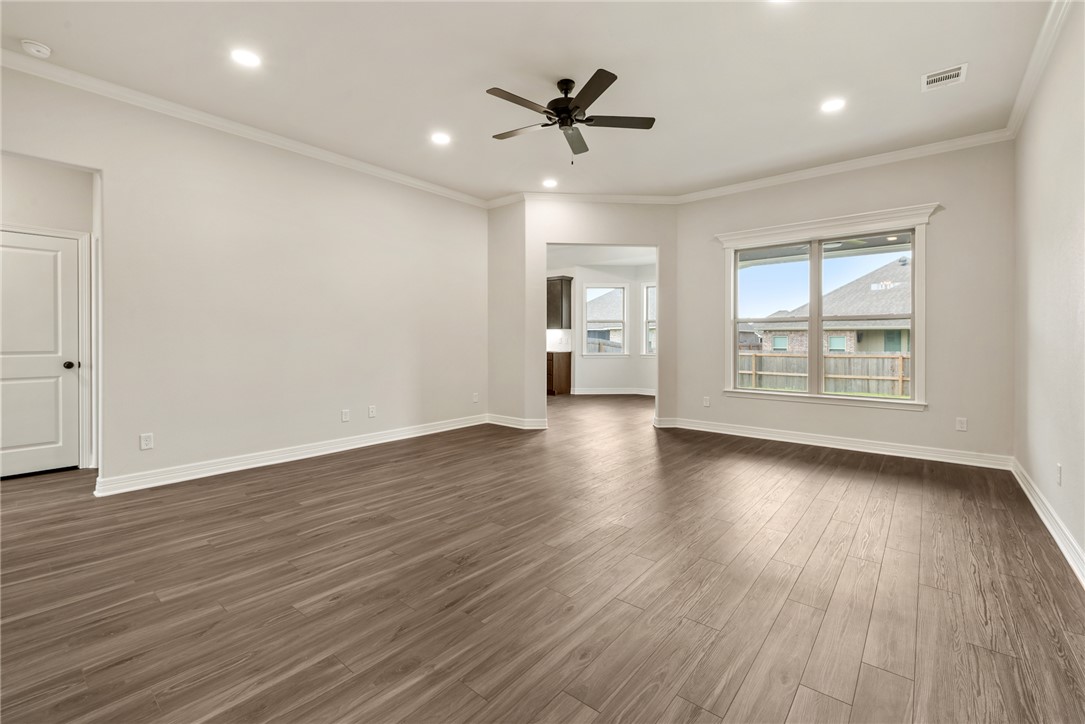 2813 Spector Drive Bryan, TX 77808 - Photo 8 of 42 a view of an empty room with a window and wooden floor