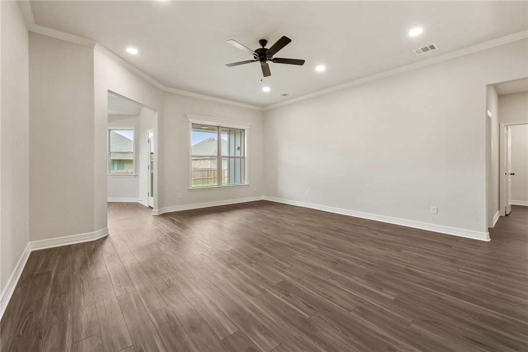 2813 Spector Drive Bryan, TX 77808 - Photo 10 of 42 an empty room with wooden floor and windows