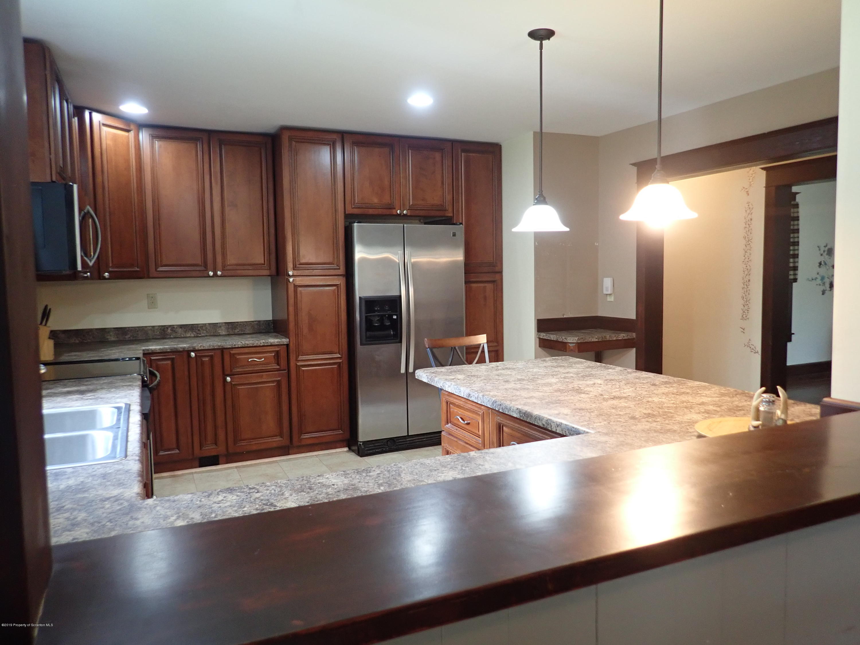 1936 Ridge Road, Unit SOUTH Montrose, PA 18801 - Photo 2 of 34 a kitchen with stainless steel appliances granite countertop a refrigerator a sink a stove and oven