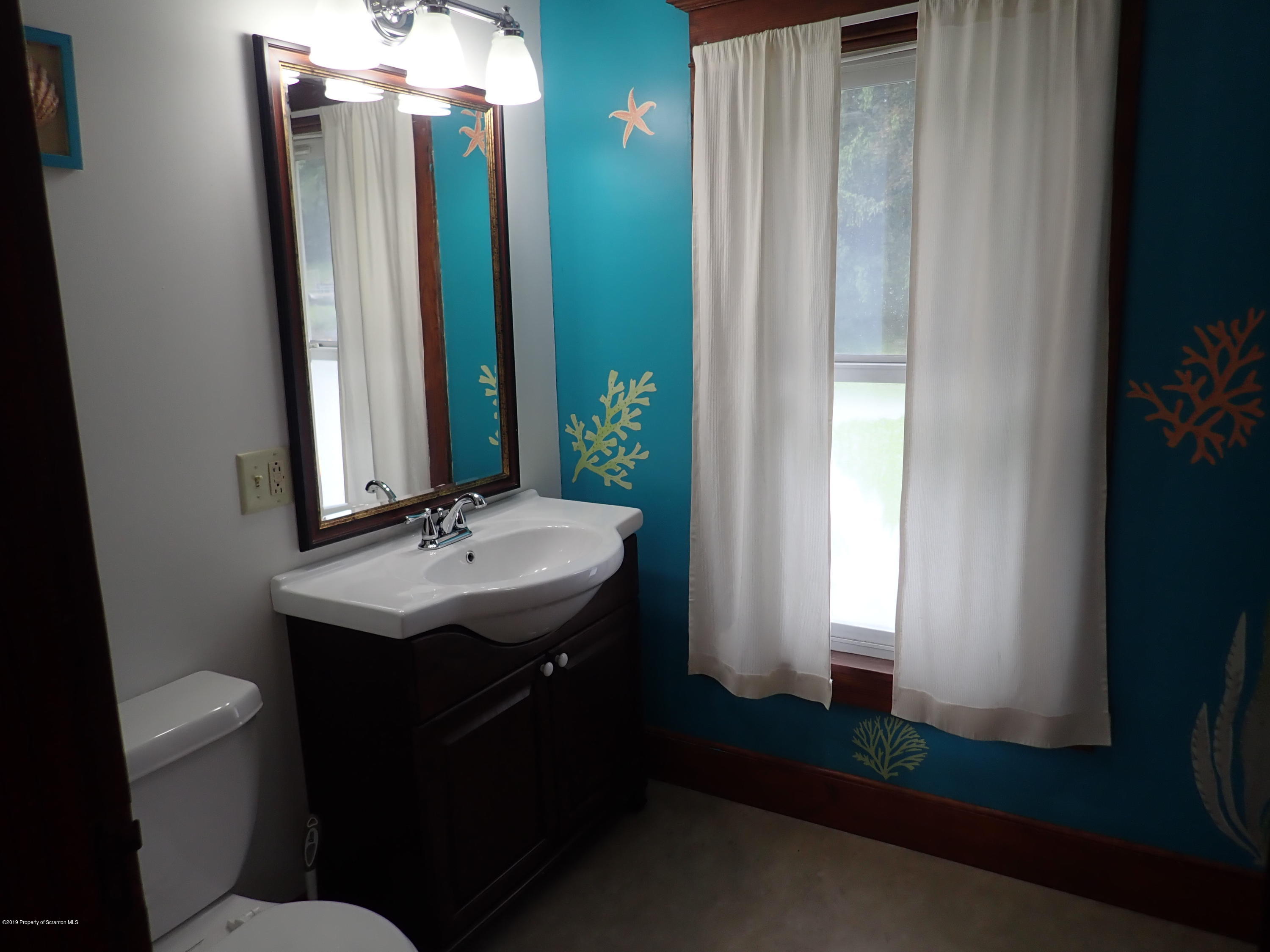 1936 Ridge Road, Unit SOUTH Montrose, PA 18801 - Photo 21 of 34 a bathroom with a sink a toilet and a mirror