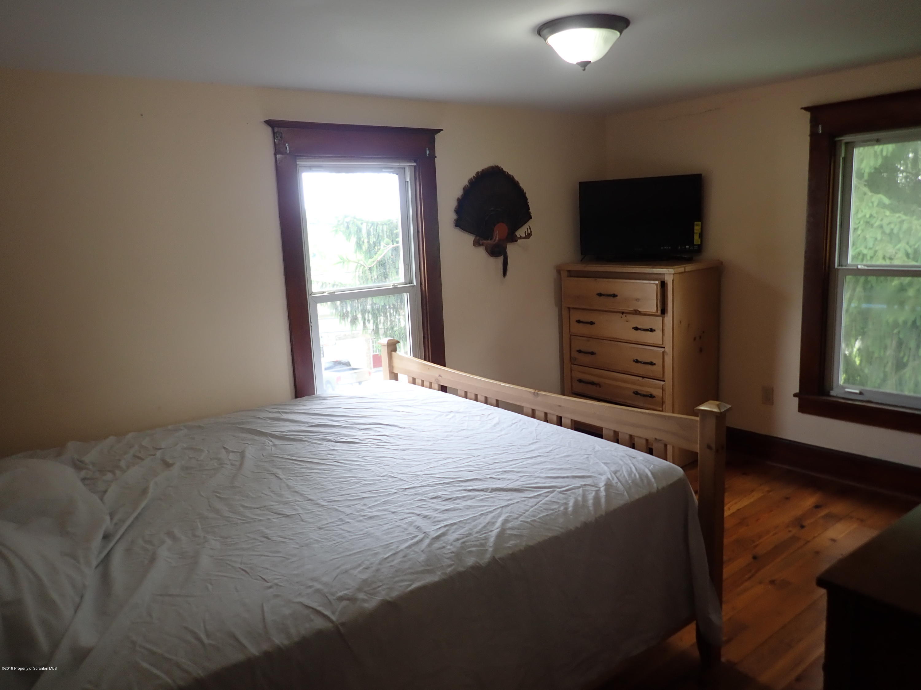 1936 Ridge Road, Unit SOUTH Montrose, PA 18801 - Photo 24 of 34 a bedroom with a bed and a flat screen tv