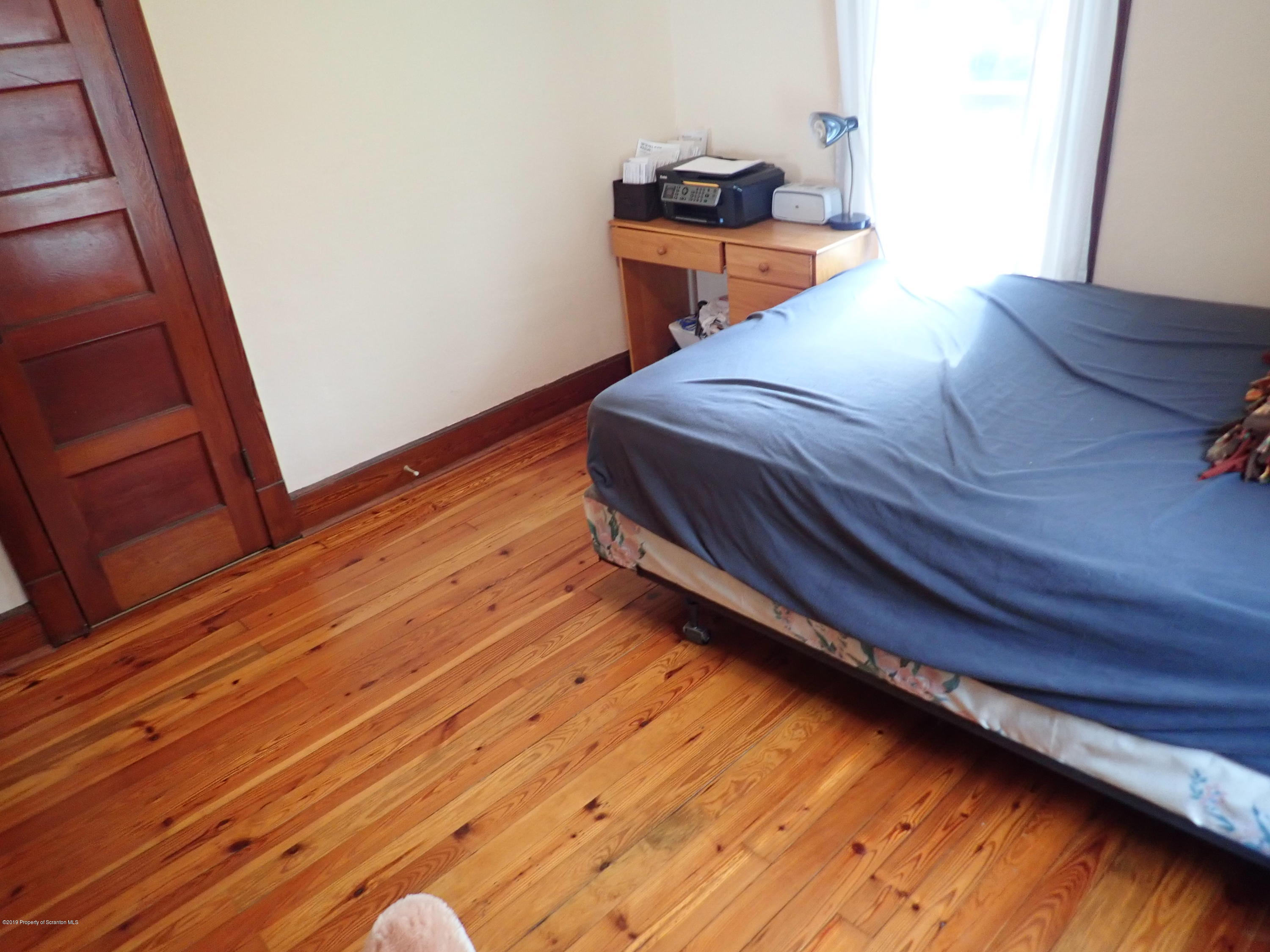 1936 Ridge Road, Unit SOUTH Montrose, PA 18801 - Photo 25 of 34 a bedroom with a bed and wooden floor
