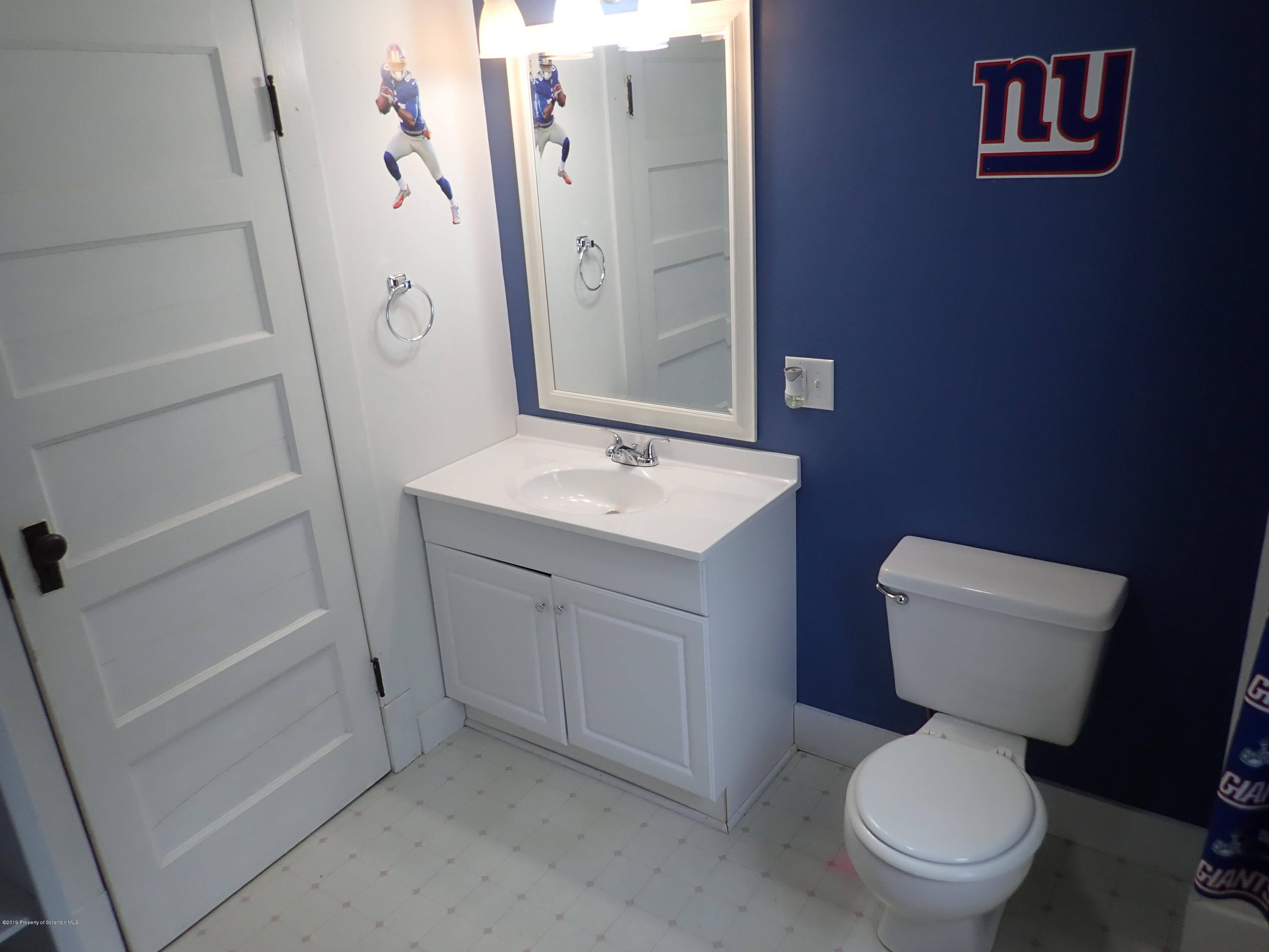 1936 Ridge Road, Unit SOUTH Montrose, PA 18801 - Photo 26 of 34 a white toilet sitting next to a bathroom sink
