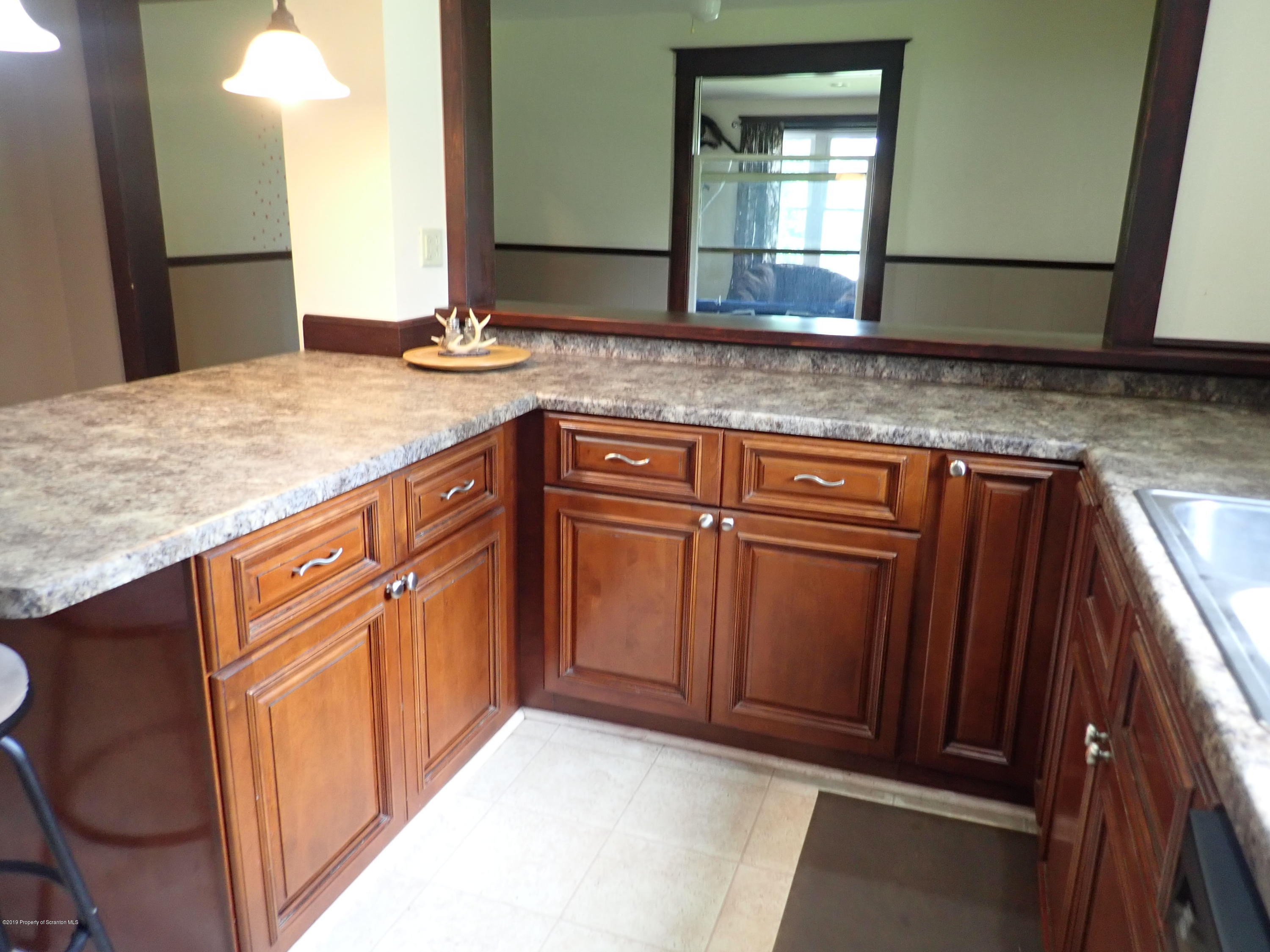 1936 Ridge Road, Unit SOUTH Montrose, PA 18801 - Photo 3 of 34 a bathroom with a granite countertop sink and a mirror