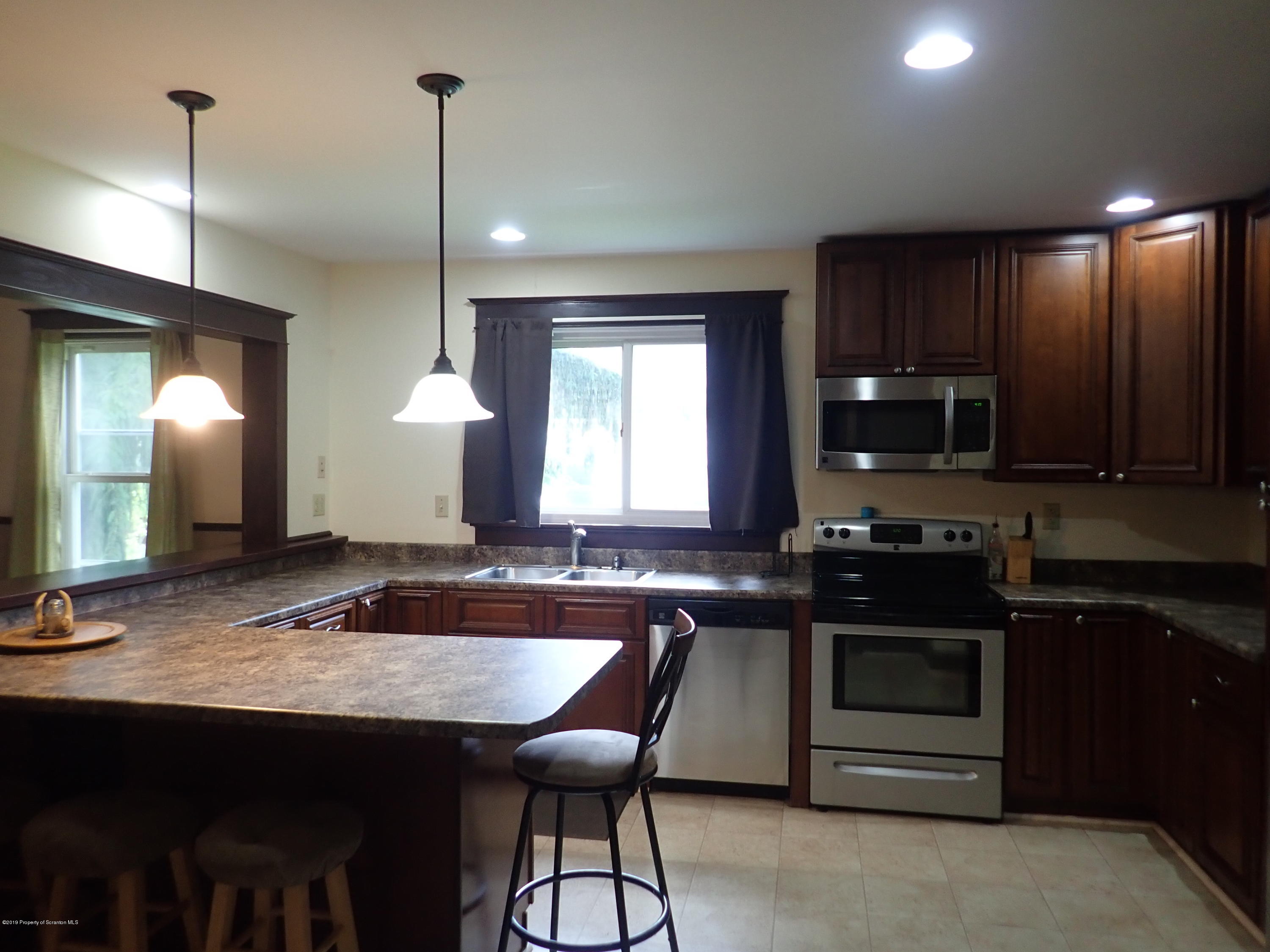 1936 Ridge Road, Unit SOUTH Montrose, PA 18801 - Photo 4 of 34 a kitchen with granite countertop a sink cabinets and window