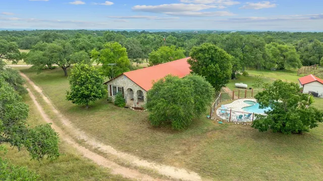 an aerial view of a house with garden space and street view