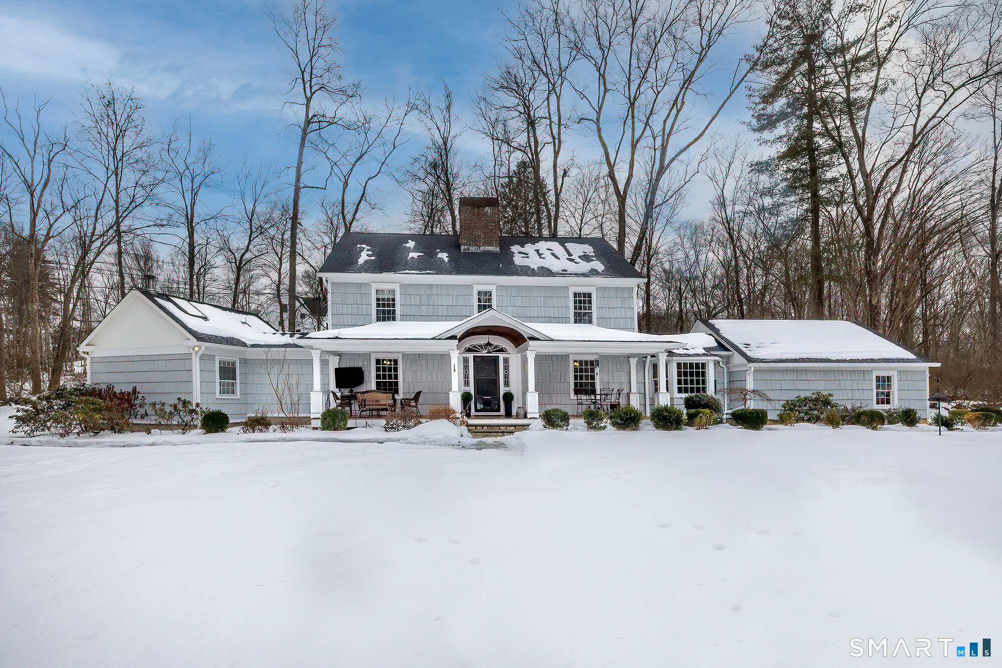6 Downe Lane Wilton, CT 06897 - Photo 1 of 1 a front view of a building with large trees