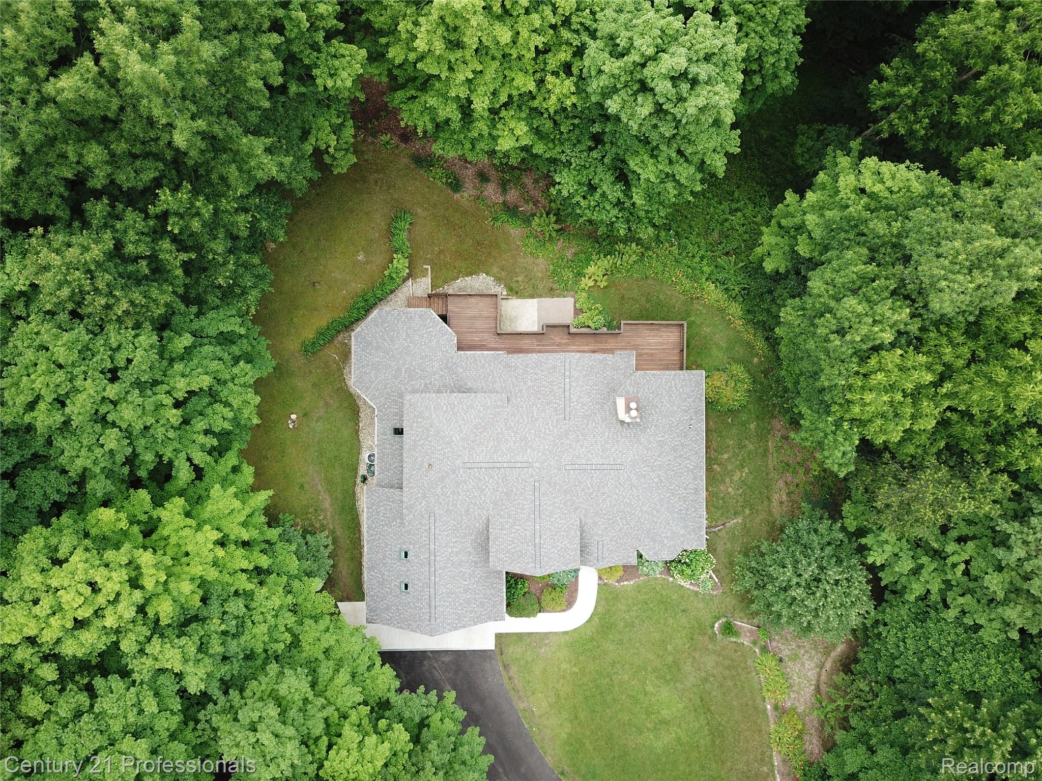 9867 Rainbow Ridge Drive Schoolcraft, MI 49087 - Photo 9 of 82 Architectural shingle roof and a multi-level wood deck surrounded by mature trees