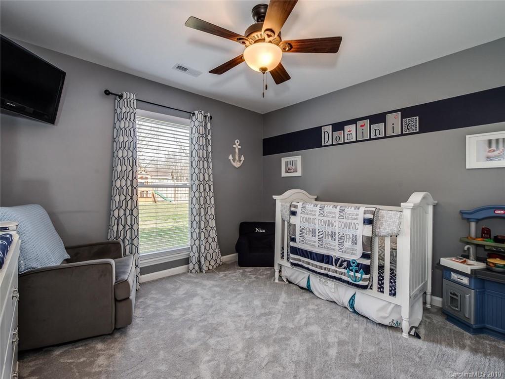 10118 Fairway Ridge Road Charlotte, NC 28277 - Photo 14 of 23 a bedroom with furniture and a flat screen tv