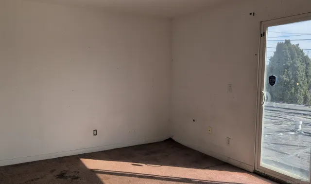 a view of a room with wooden floor