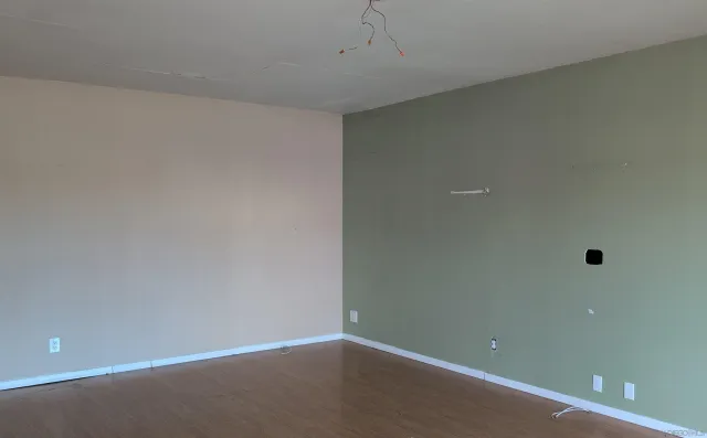 an empty room with ceiling fan