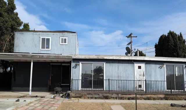 a view of a house with a snow in the yard
