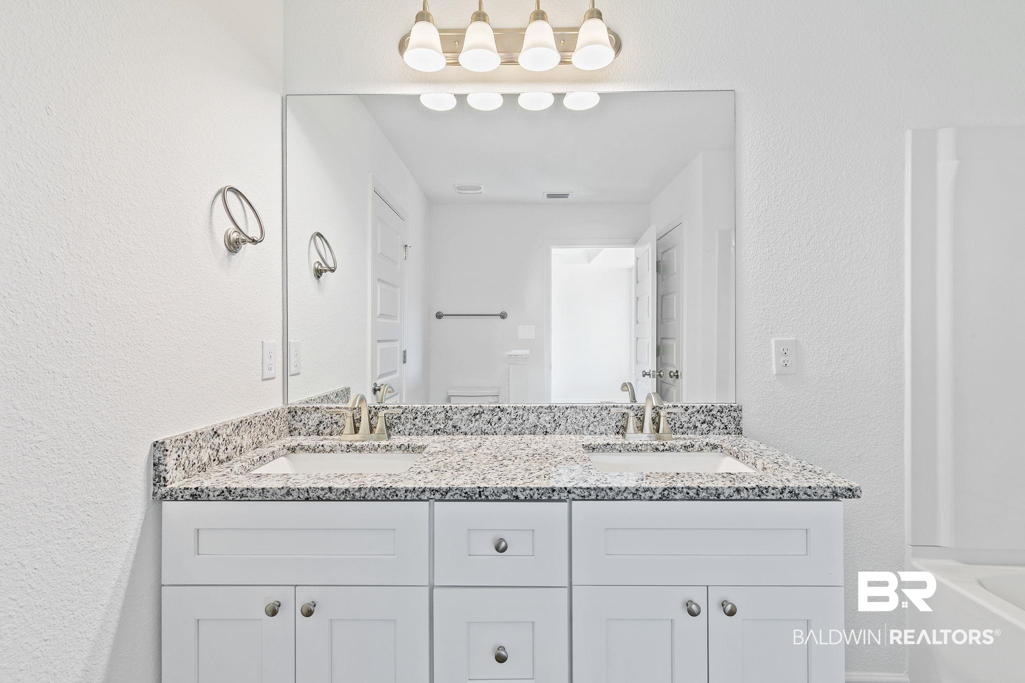 16014 Alabama Avenue Silverhill, AL 36576 - Photo 23 of 50 Bathroom featuring a bath, toilet, and vanity
