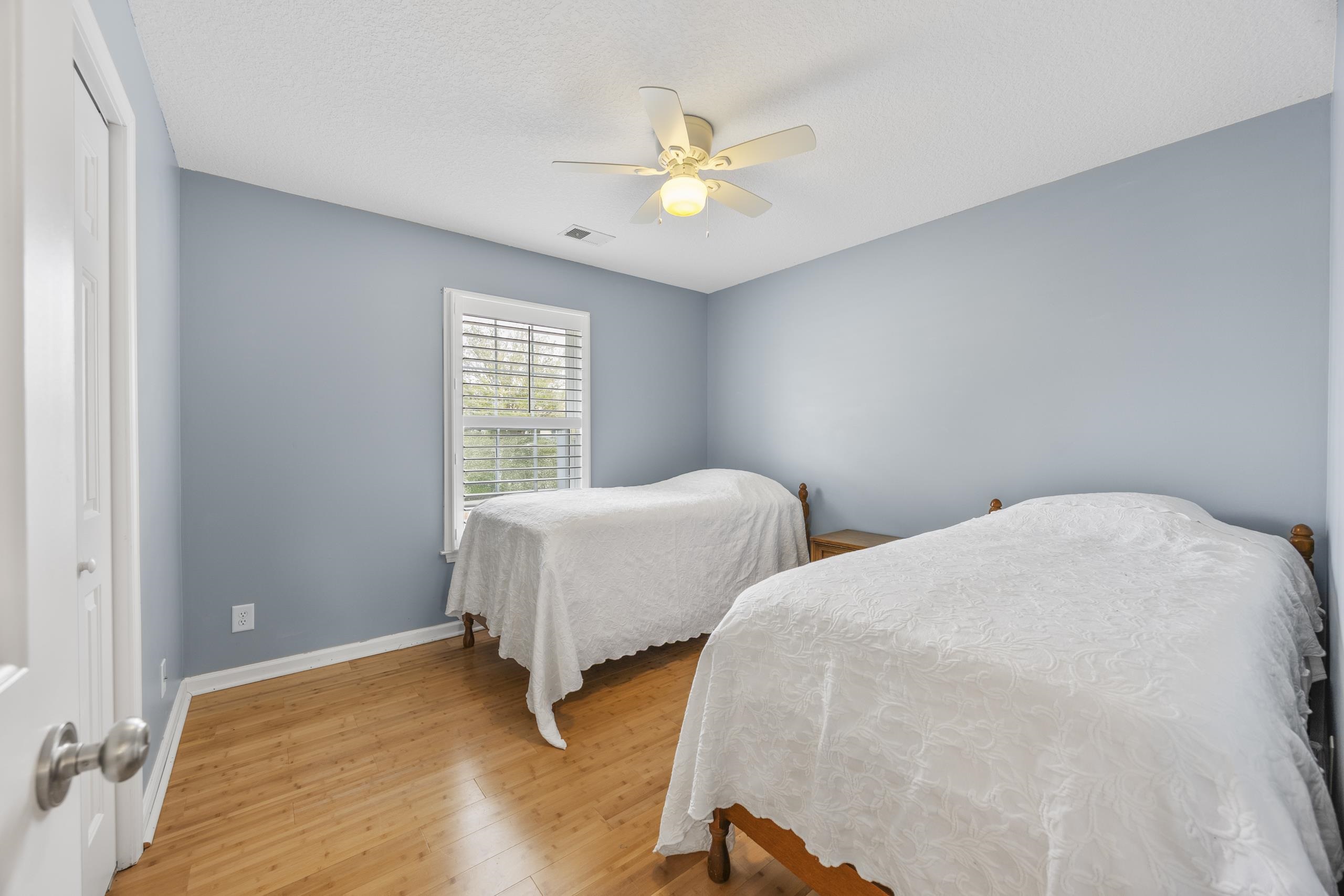 722 Downing Court Longs, SC 29568 - Photo 18 of 40 Bedroom featuring light wood-style floors, ceiling fan, and a closet